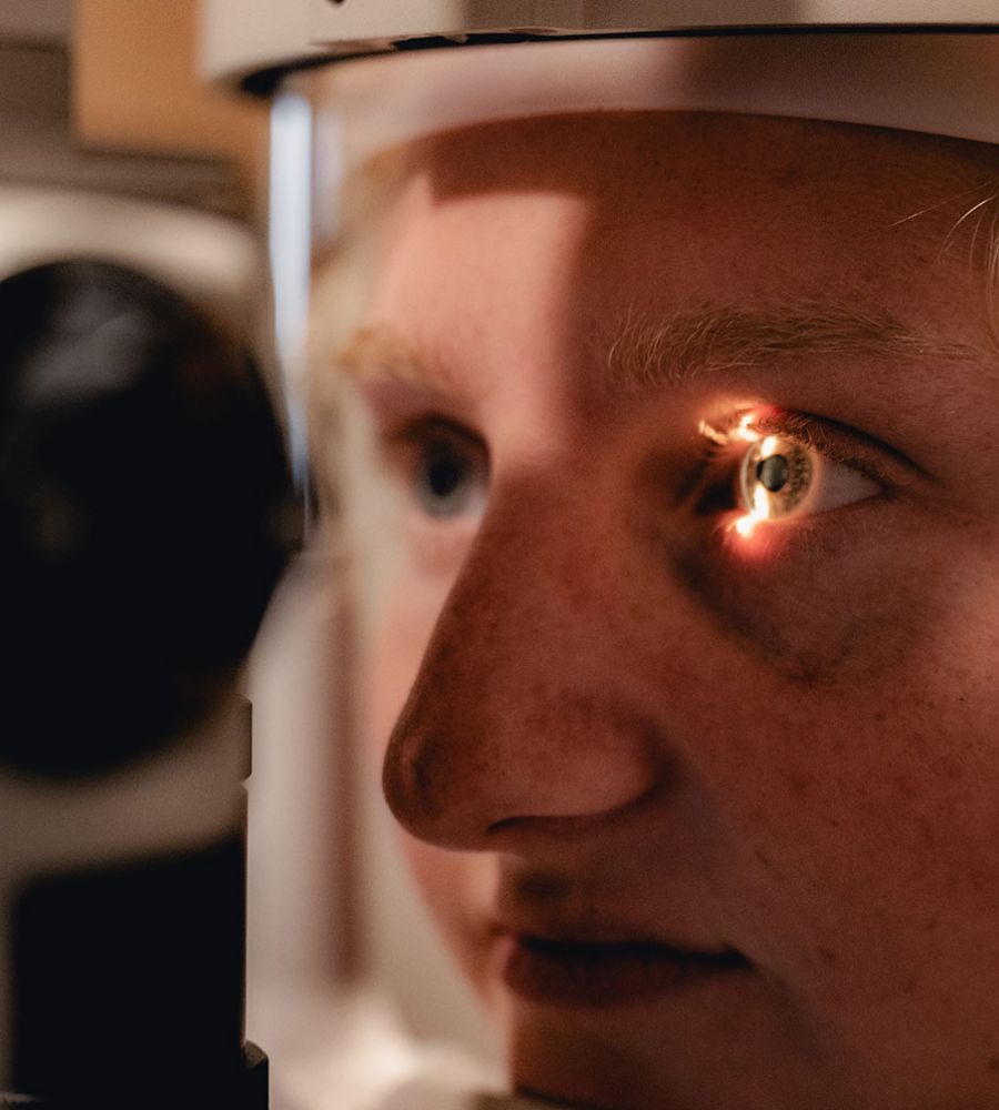 Woman receiving a comprehensive eye exam at Envision Eyecare in Asheville, NC